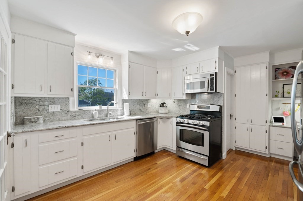 28 Columbia Road Marblehead, MA 01945 - Photo 21 of 42 a kitchen with granite countertop a sink stainless steel appliances and cabinets