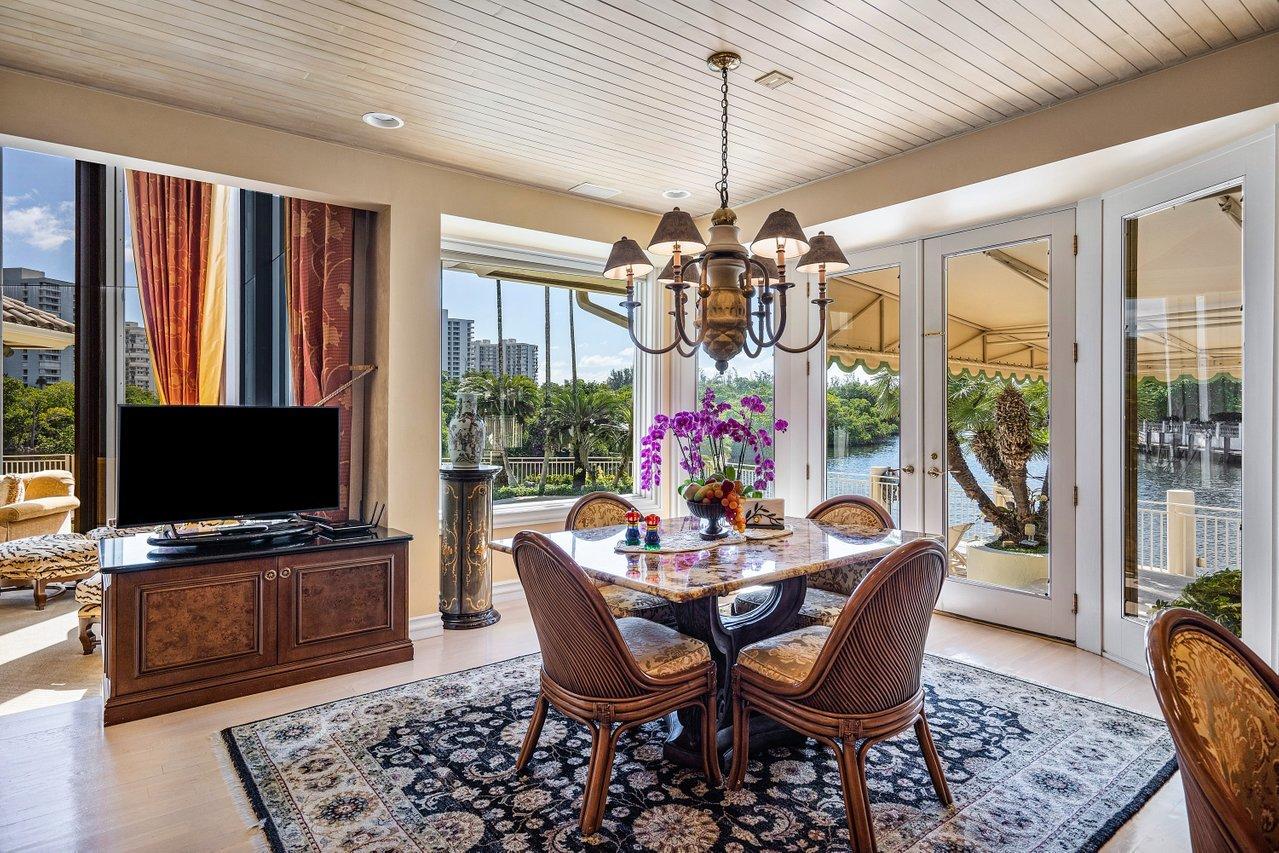 750 Tern Point Circle Boca Raton, FL 33431 - Photo 19 of 81 a view of a dining room with furniture wooden floor and chandelier