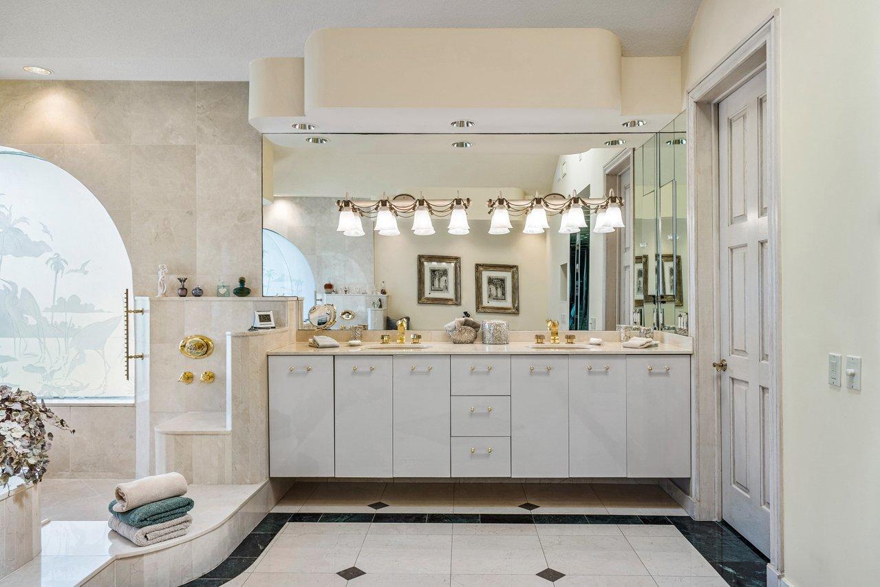 750 Tern Point Circle Boca Raton, FL 33431 - Photo 33 of 81 a bathroom with a sink mirror and a shower
