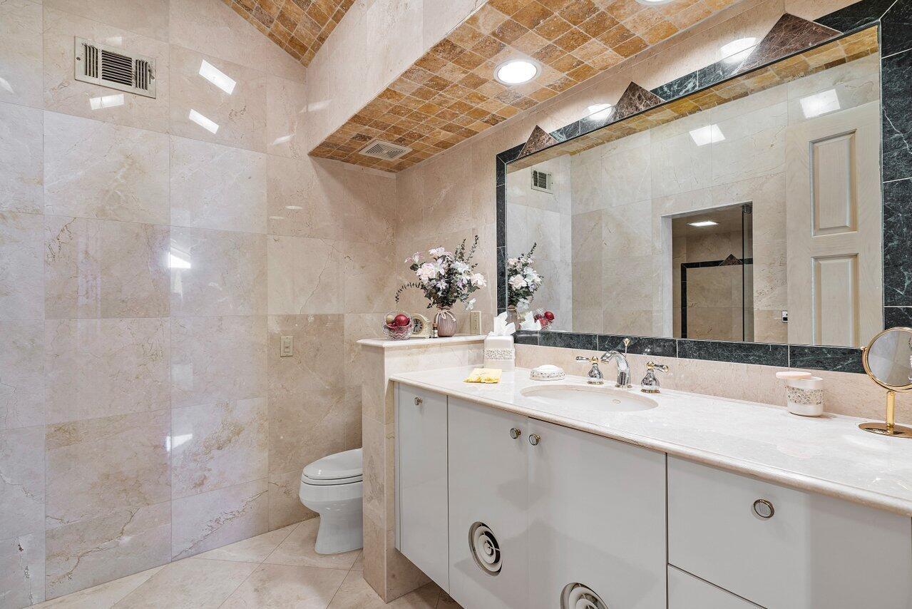 750 Tern Point Circle Boca Raton, FL 33431 - Photo 44 of 81 a bathroom with a double vanity sink toilet and a mirror