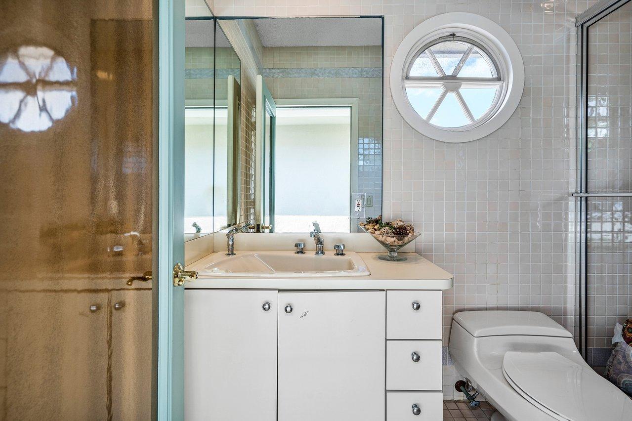 750 Tern Point Circle Boca Raton, FL 33431 - Photo 50 of 81 a bathroom with a toilet a sink and a mirror