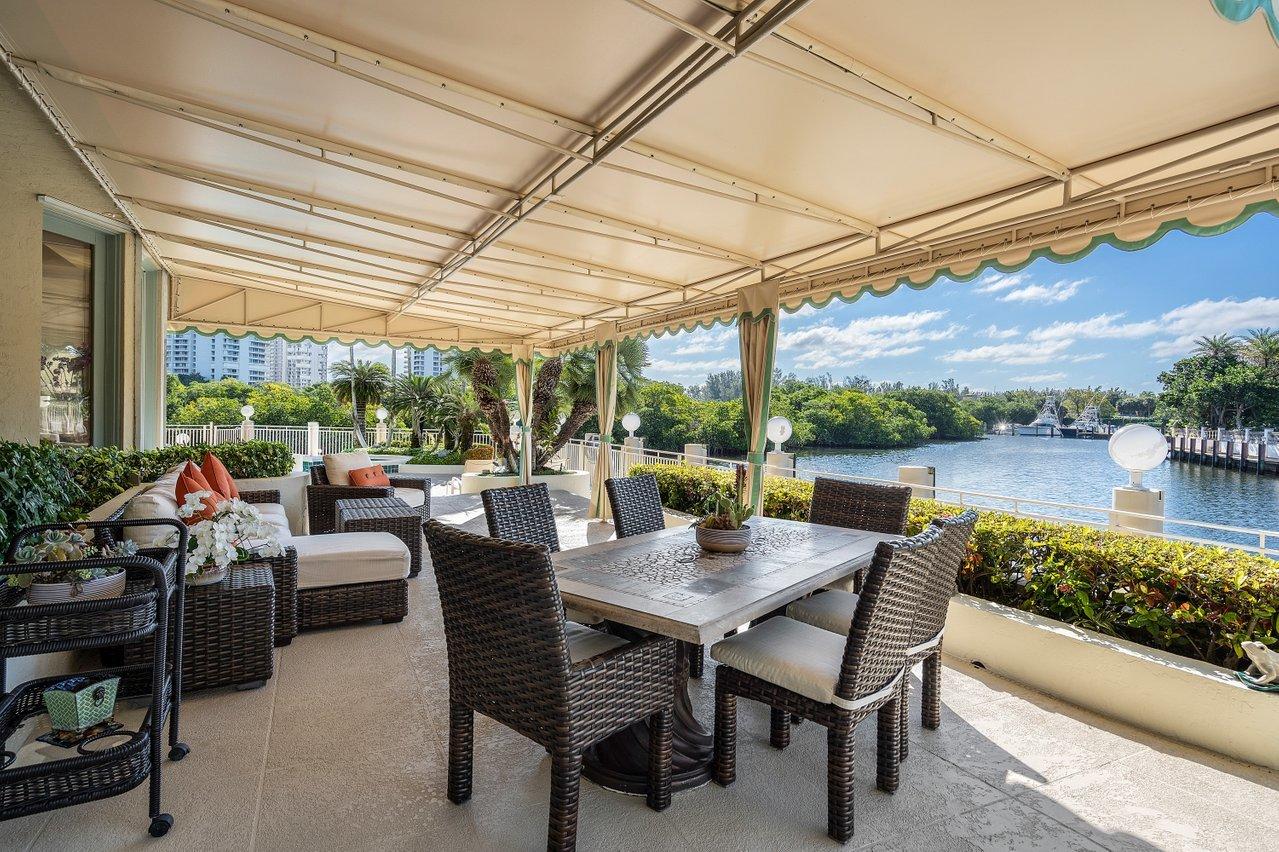 750 Tern Point Circle Boca Raton, FL 33431 - Photo 52 of 81 a view of a patio with a table chairs and a backyard