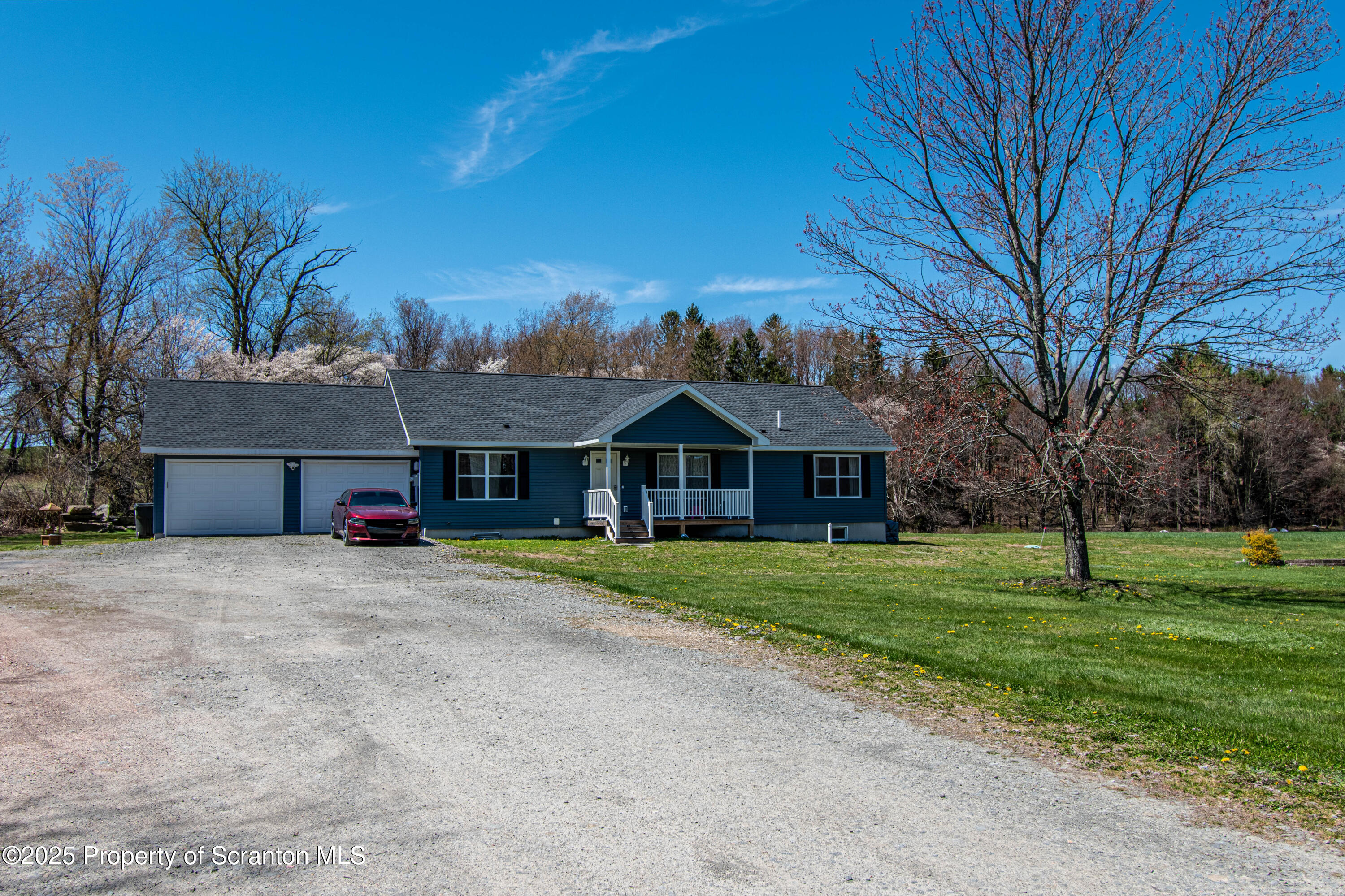 151 Sandy Banks Road Carbondale, PA 18407 - Photo 1 of 36 a front view of a house with a yard and trees