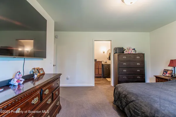 a bedroom with a bed and a television