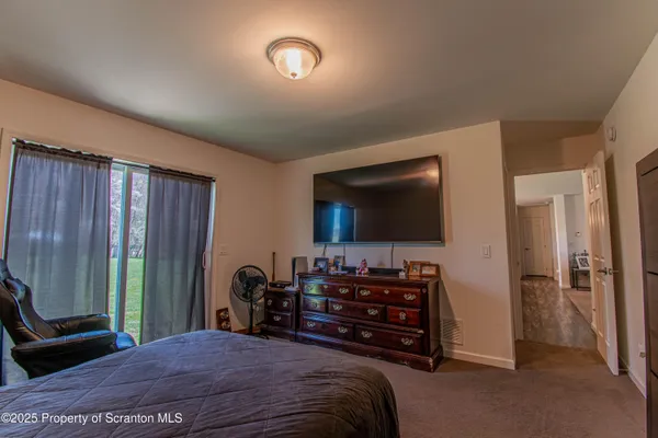 a bedroom with a bed and a television in it