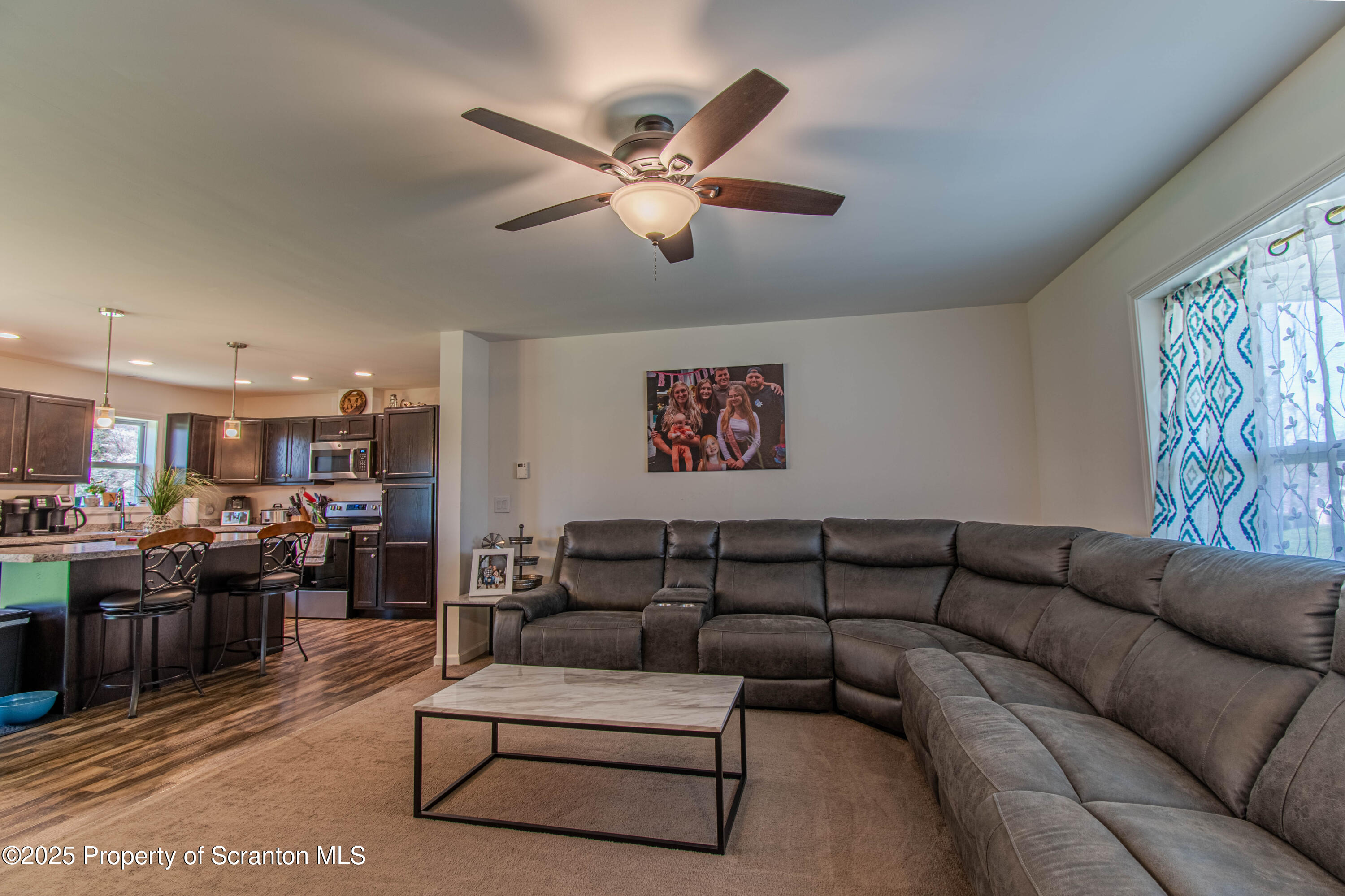 151 Sandy Banks Road Carbondale, PA 18407 - Photo 6 of 36 a living room with furniture kitchen view and a chandelier