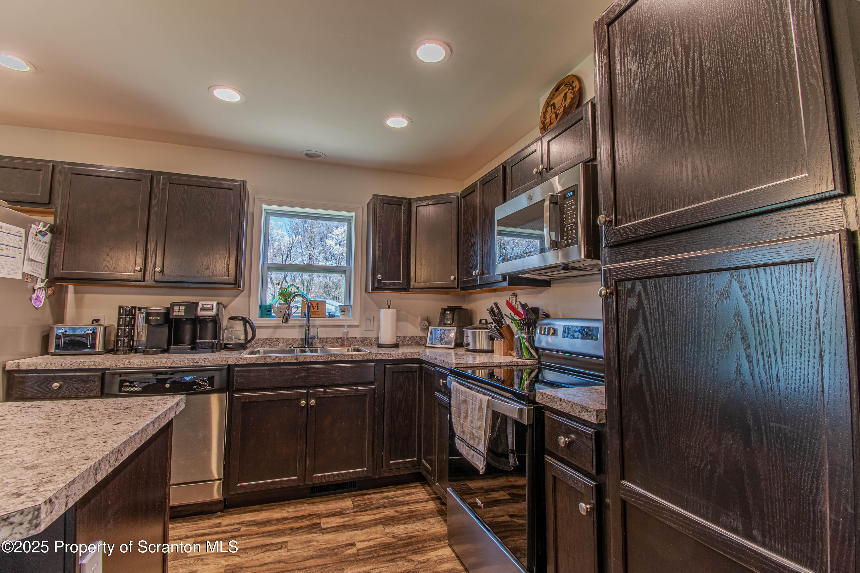 151 Sandy Banks Road Carbondale, PA 18407 - Photo 9 of 36 a kitchen with granite countertop stainless steel appliances and sink