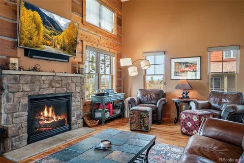 a living room with furniture a fireplace and window