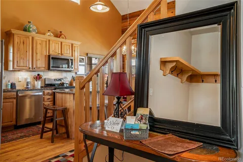 a view of a workspace with furniture and a kitchen