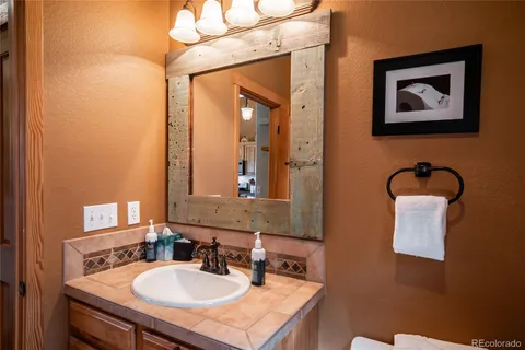 a bathroom with a sink vanity and mirror