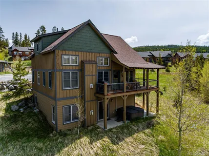 a view of a house with a small yard and wooden fence
