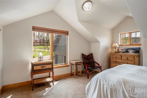 a bedroom with furniture and a window