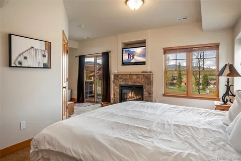 a bedroom with a large bed and a window