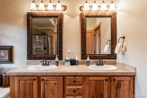a bathroom with a sink a mirror and a vanity