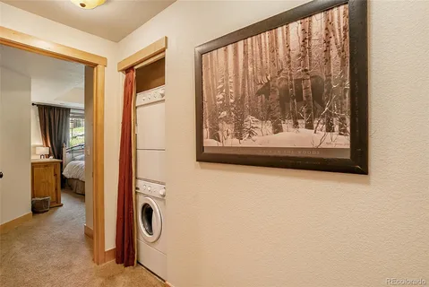 a view of a hallway with a door and a window
