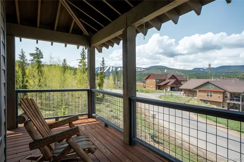 a view of a balcony with lake view and wooden floor