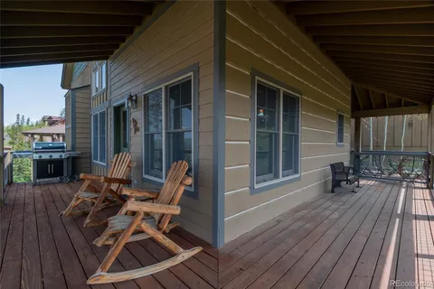 a view of a patio with table and chairs and wooden floor