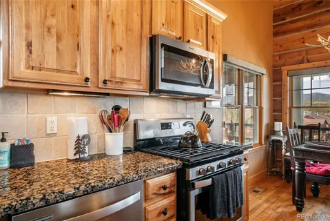 a kitchen with stainless steel appliances granite countertop a stove and a microwave