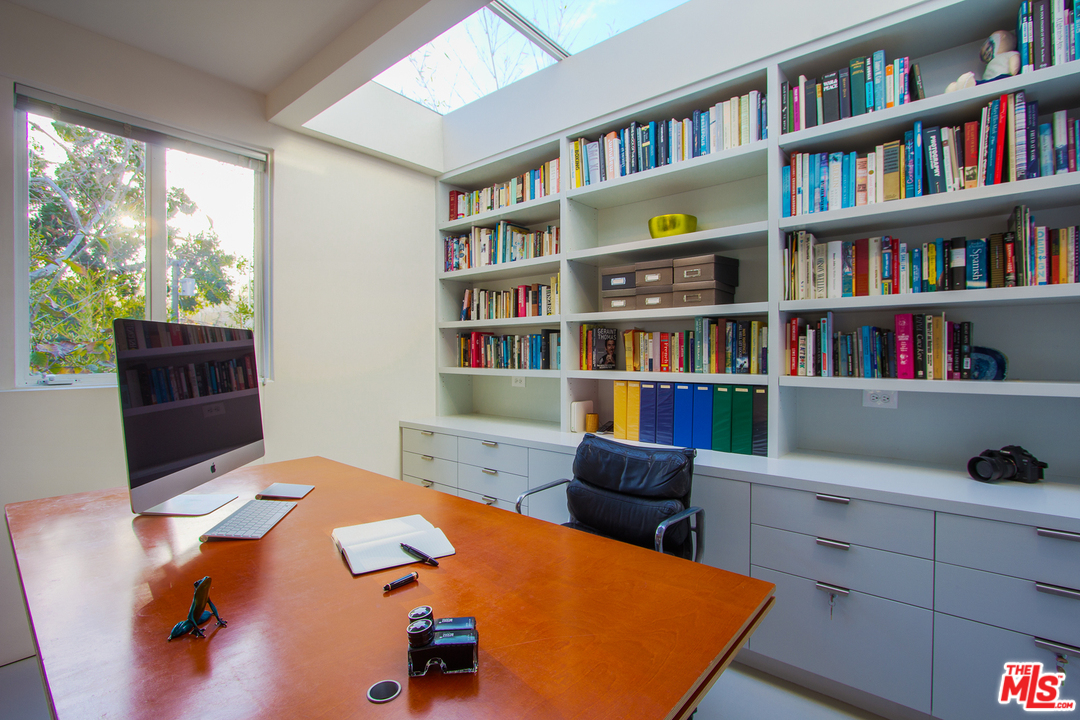 469 Upper Mesa Road Santa Monica, CA 90402 - Photo 12 of 33 a view of a workspace with furniture and a bookshelf