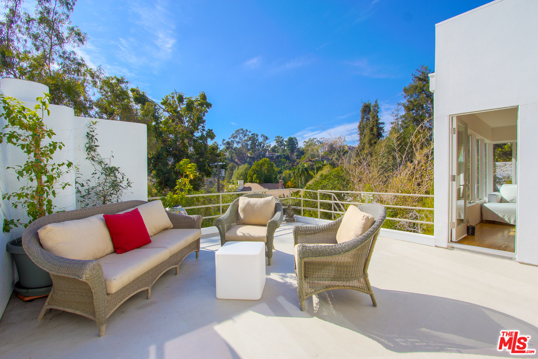 469 Upper Mesa Road Santa Monica, CA 90402 - Photo 16 of 33 a view of a patio with couches chairs and a potted plant