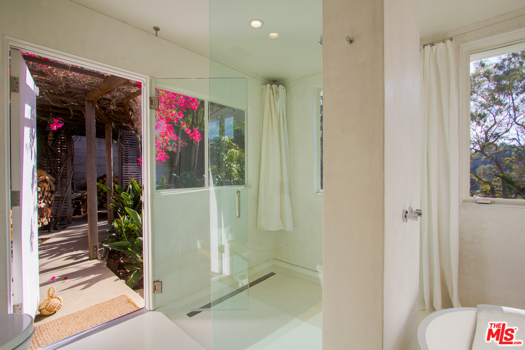 469 Upper Mesa Road Santa Monica, CA 90402 - Photo 19 of 33 a very nice looking room with a glass door shower and furniture