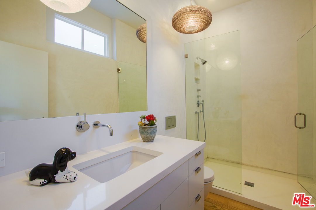 469 Upper Mesa Road Santa Monica, CA 90402 - Photo 23 of 33 a bathroom with a sink and a mirror