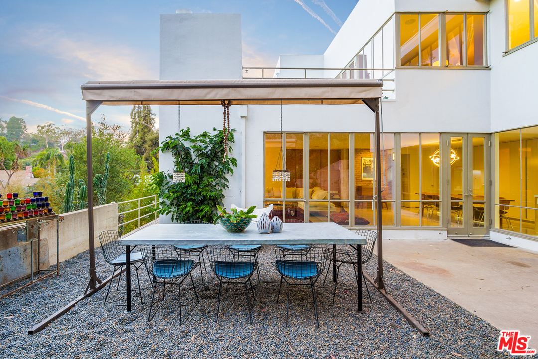 469 Upper Mesa Road Santa Monica, CA 90402 - Photo 28 of 33 a view of a patio with table and chairs and potted plants