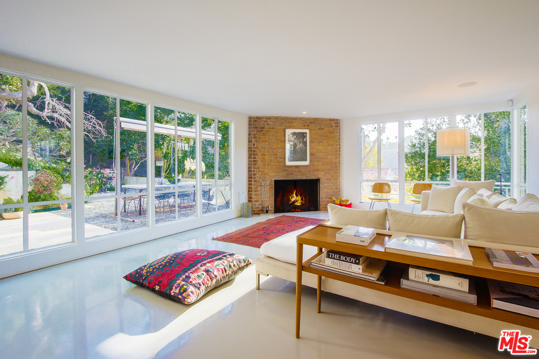 469 Upper Mesa Road Santa Monica, CA 90402 - Photo 6 of 33 a living room with furniture fireplace and large window