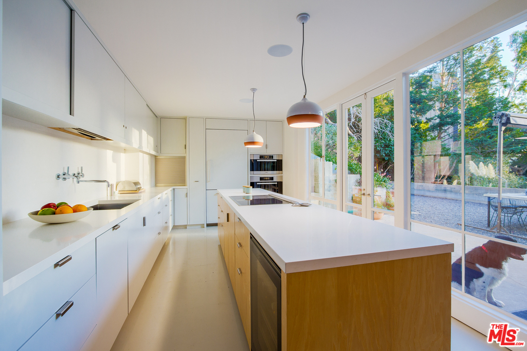 469 Upper Mesa Road Santa Monica, CA 90402 - Photo 8 of 33 a large kitchen with stainless steel appliances kitchen island granite countertop a sink and cabinets