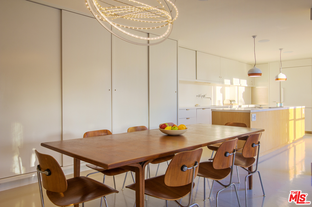 469 Upper Mesa Road Santa Monica, CA 90402 - Photo 9 of 33 a view of a dining table and chairs in the kitchen