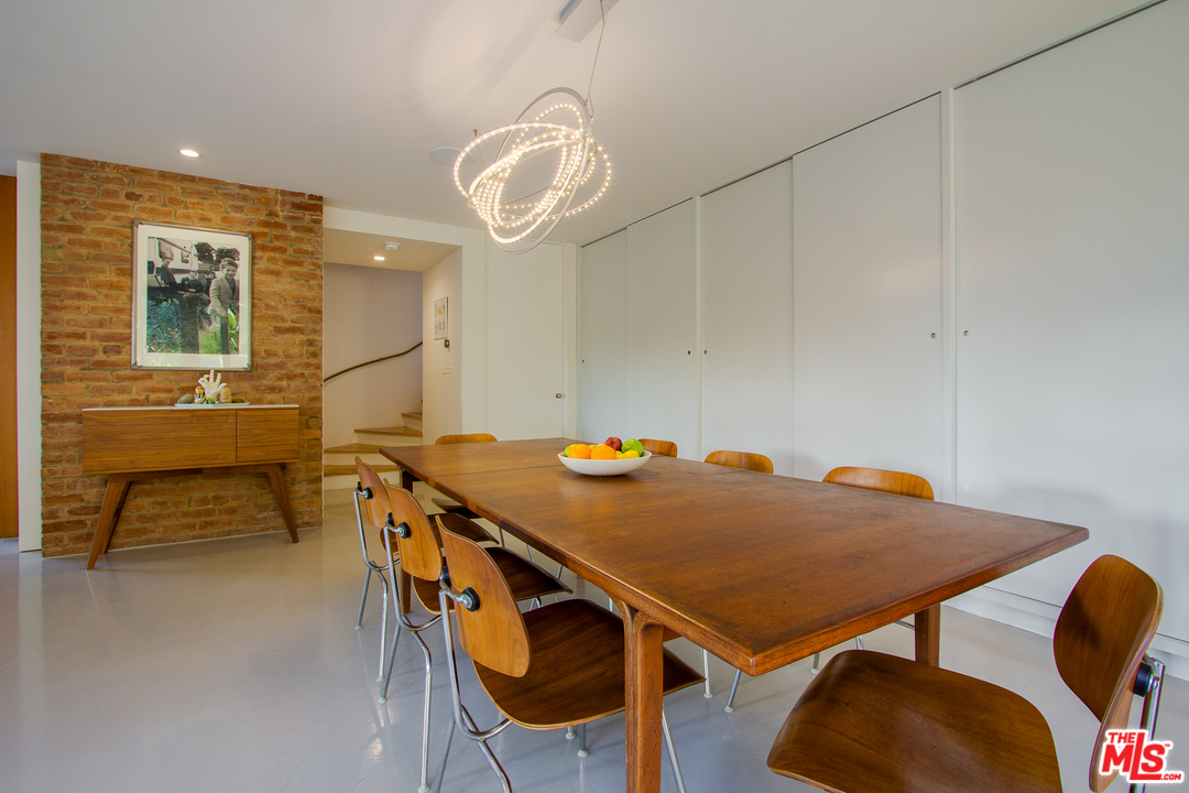 469 Upper Mesa Road Santa Monica, CA 90402 - Photo 10 of 33 a view of a dining room with furniture and wooden floor