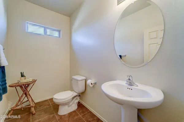 a bathroom with a sink a mirror and a toilet
