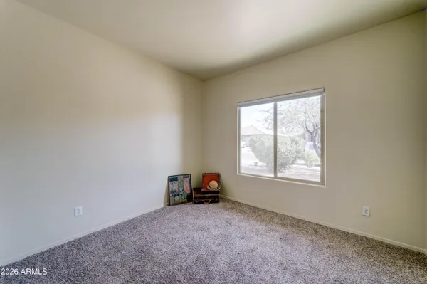 a view of a livingroom with a ceiling fan and window
