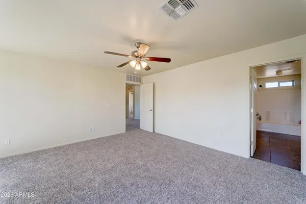 a spacious bathroom with a tub sink and mirror