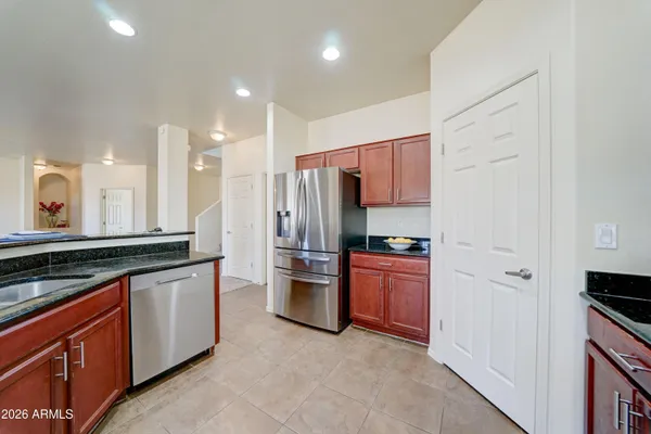a kitchen with stainless steel appliances granite countertop a refrigerator and a stove