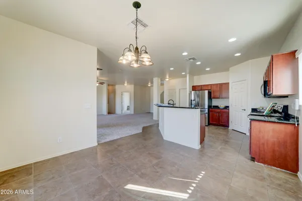 a view of a kitchen with a sink stainless steel appliances and cabinets
