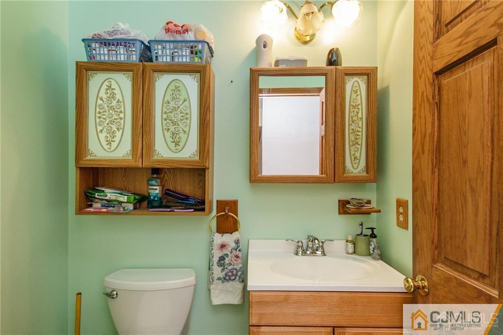 434 Burke Road Jackson, NJ 08527 - Photo 14 of 27 a bathroom with a toilet a sink and a mirror