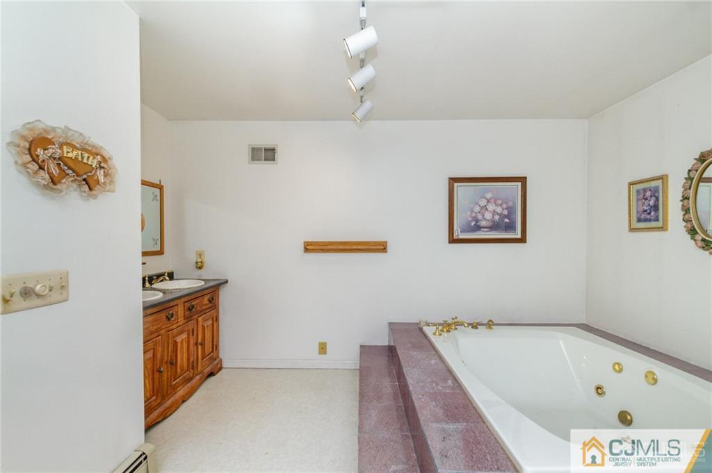 434 Burke Road Jackson, NJ 08527 - Photo 21 of 27 a bathroom with a bathtub and a window