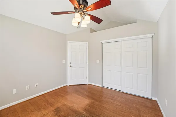 an empty room with fan and entryway