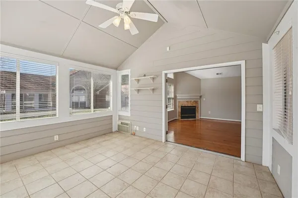 an empty room with windows and entryway