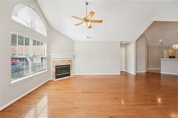a view of an empty room with a fireplace and a window