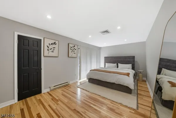 a bedroom with a large bed and a window