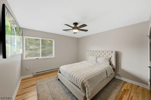 a bedroom with a large bed and a window