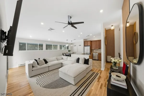 a living room with furniture and a wooden floor