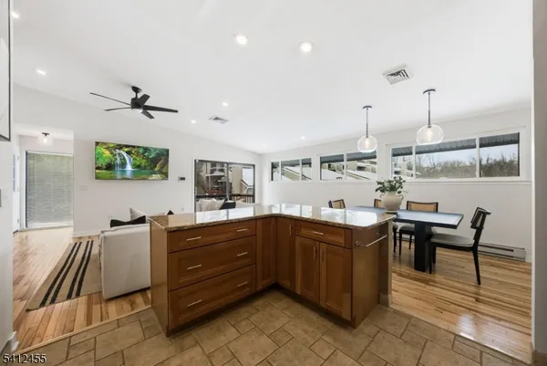 a kitchen with stainless steel appliances granite countertop a refrigerator sink and stove