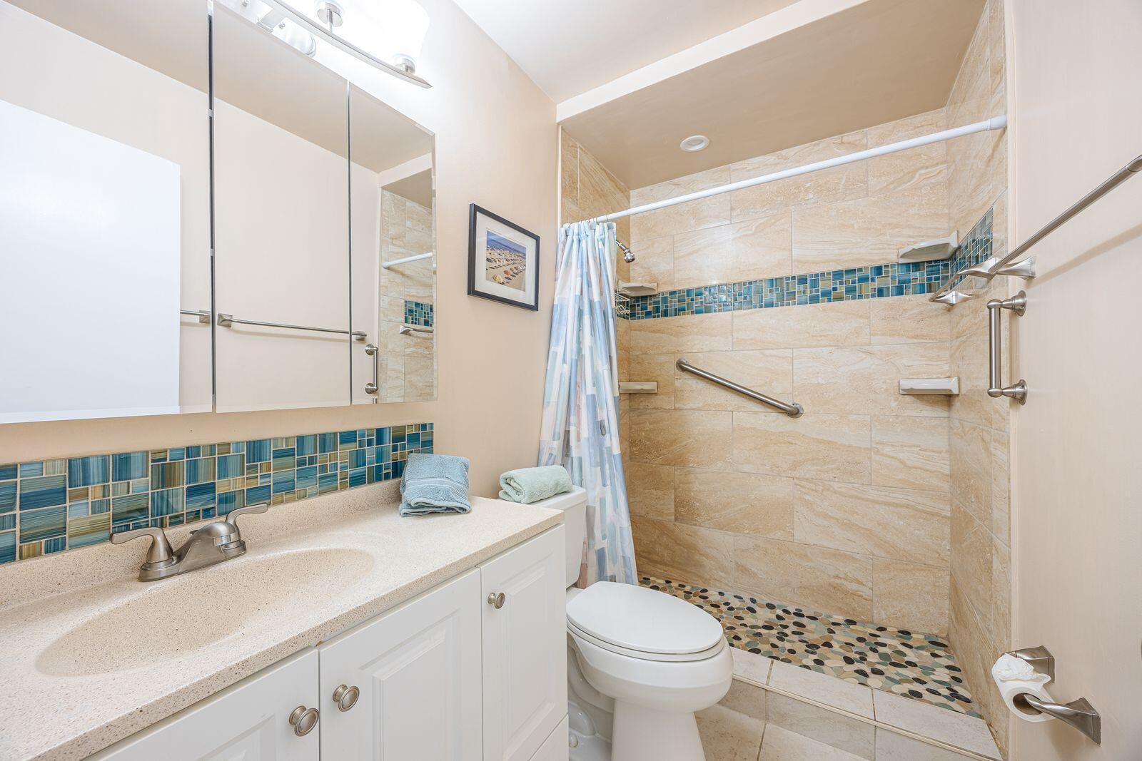 5505 North Ocean Boulevard, Unit 8108 Ocean Ridge, FL 33435 - Photo 15 of 22 a bathroom with a sink toilet a mirror and shower