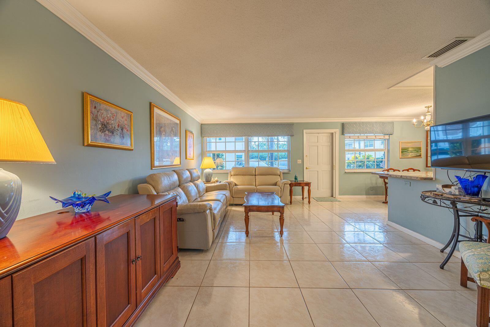 5505 North Ocean Boulevard, Unit 8108 Ocean Ridge, FL 33435 - Photo 7 of 22 a living room with couches a computer on a desk and kitchen view