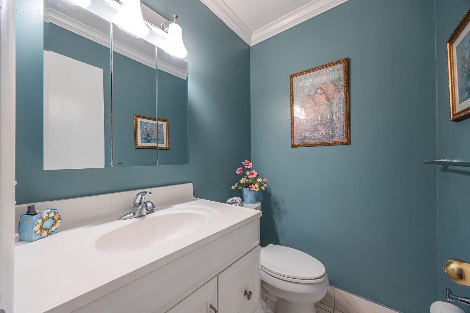 5505 North Ocean Boulevard, Unit 8108 Ocean Ridge, FL 33435 - Photo 8 of 22 a bathroom with a sink mirror vanity and a toilet