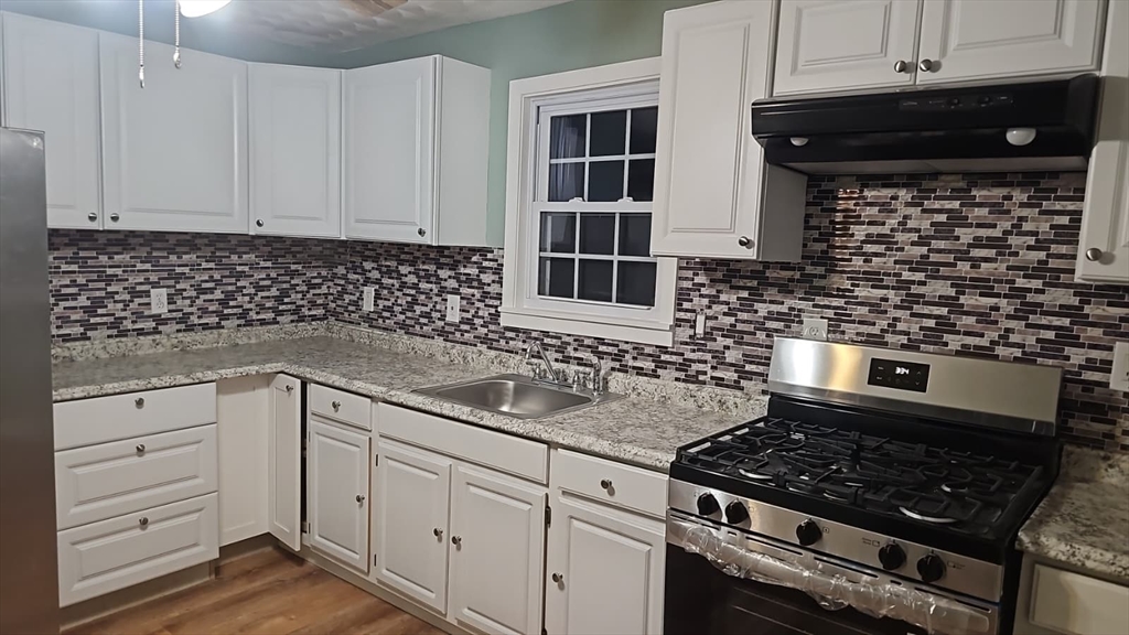 52 Fuller Street, Unit 1 Everett, MA 02149 - Photo 2 of 10 a kitchen with white cabinets and appliances
