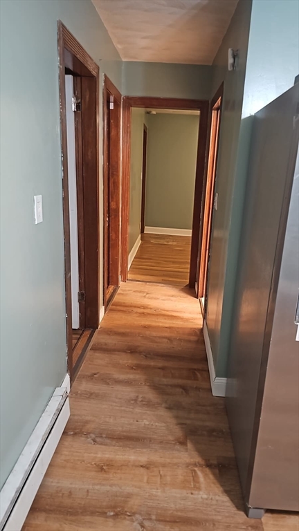 52 Fuller Street, Unit 1 Everett, MA 02149 - Photo 7 of 10 a view of a hallway with wooden floor and staircase
